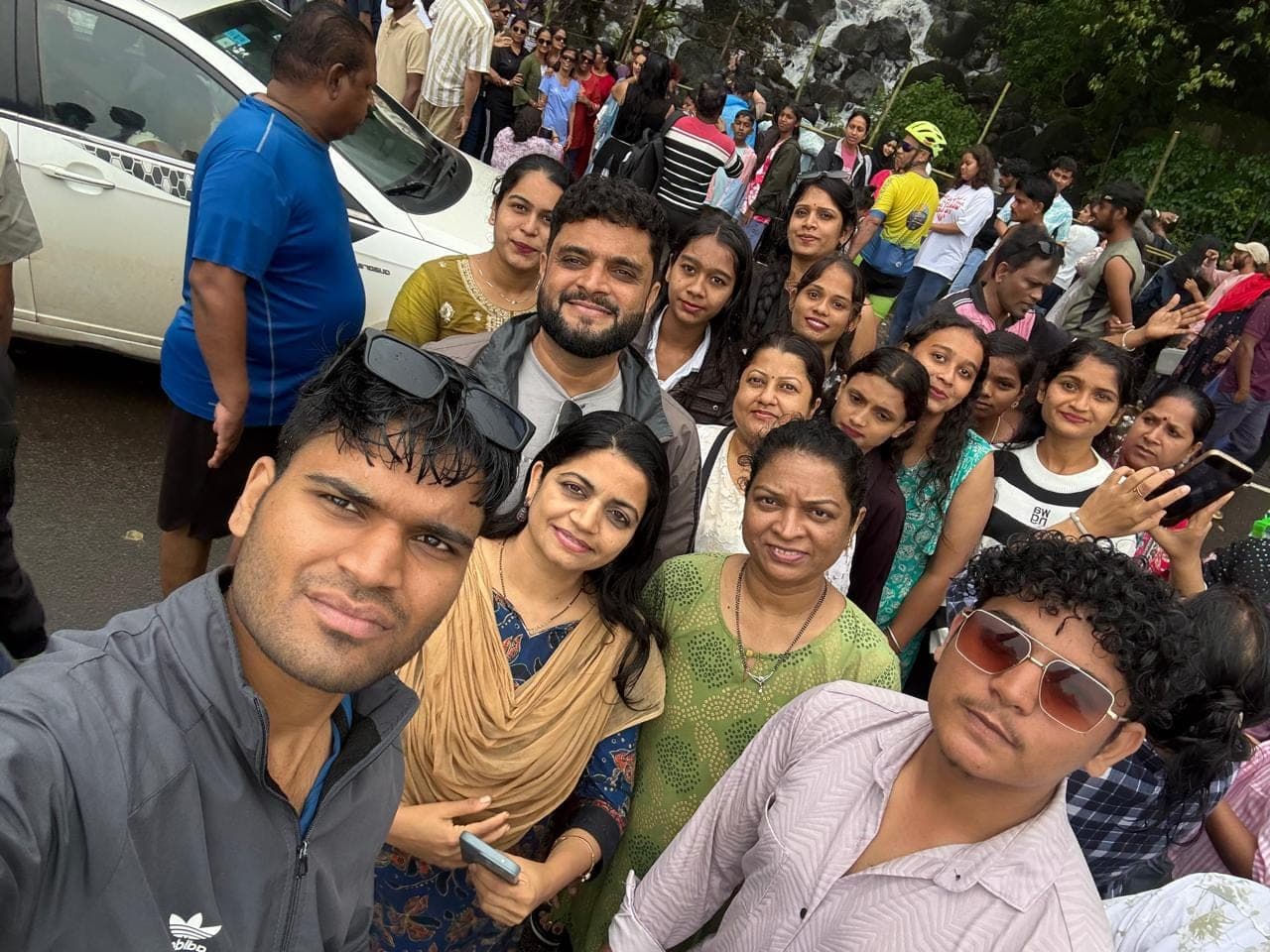 Everyone squeezing into the frame beside the bus