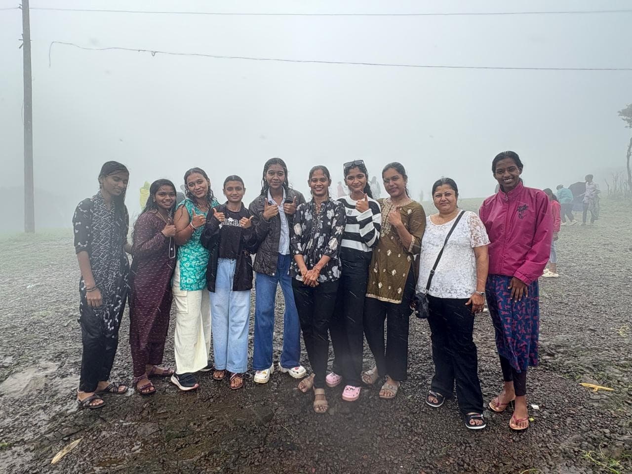 The group disappearing into the fog at the viewpoint