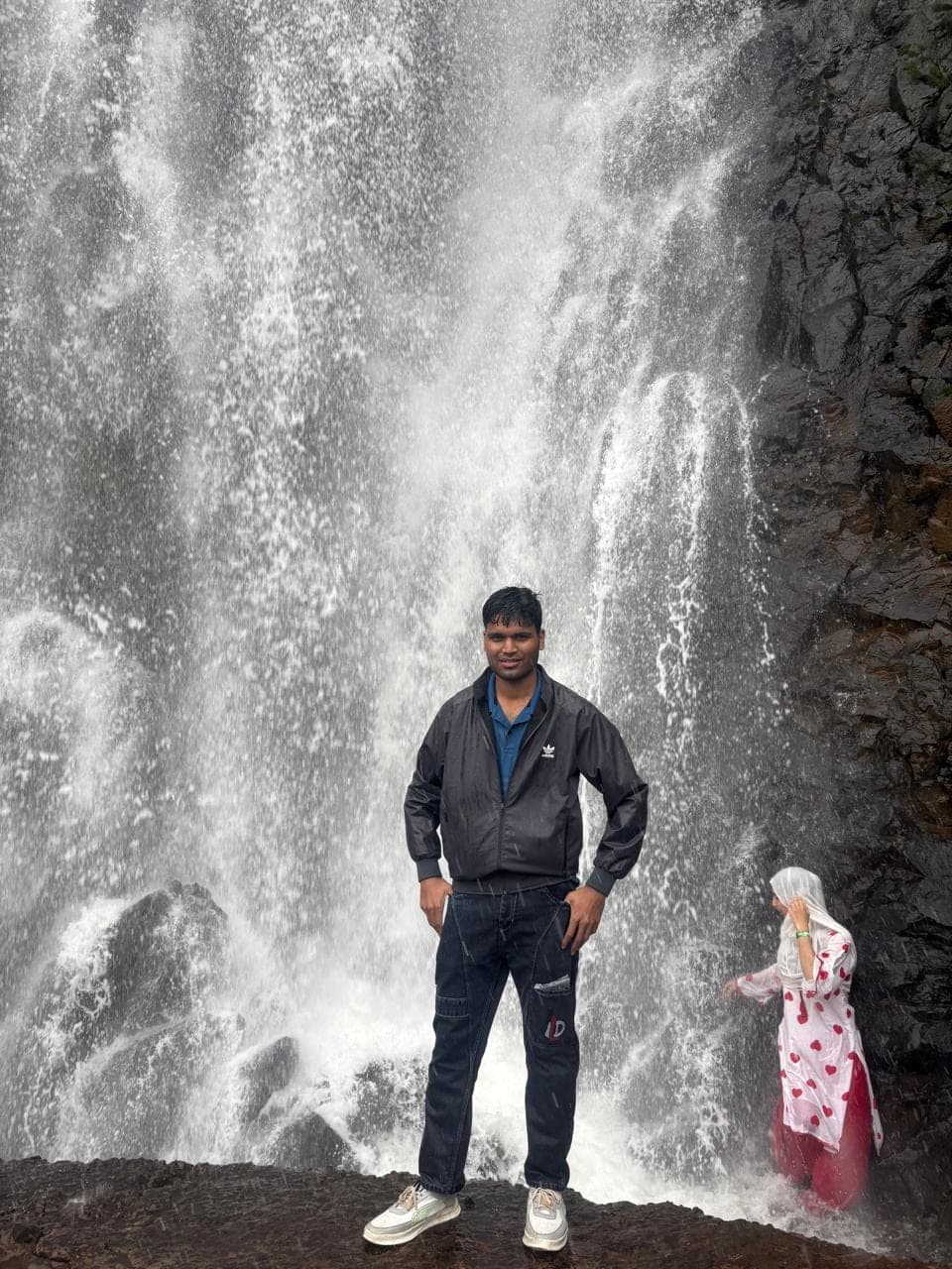 Standing alone in the spray at the base of the falls